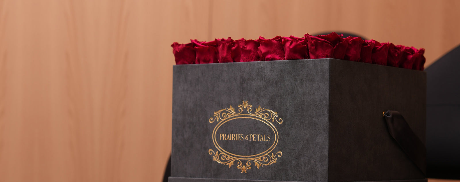 Burgundy roses in a black velvet Prairies & Petals square box