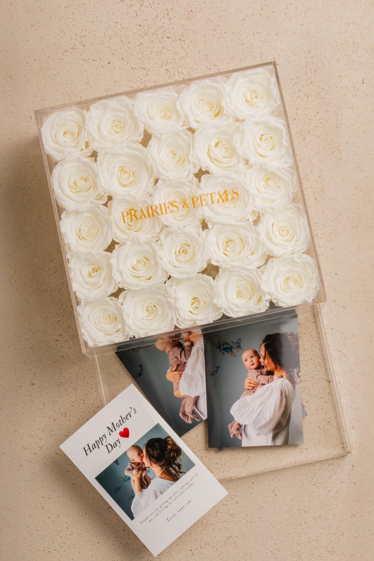 White roses in a clear acrylic Clara box with a Mother's Day card