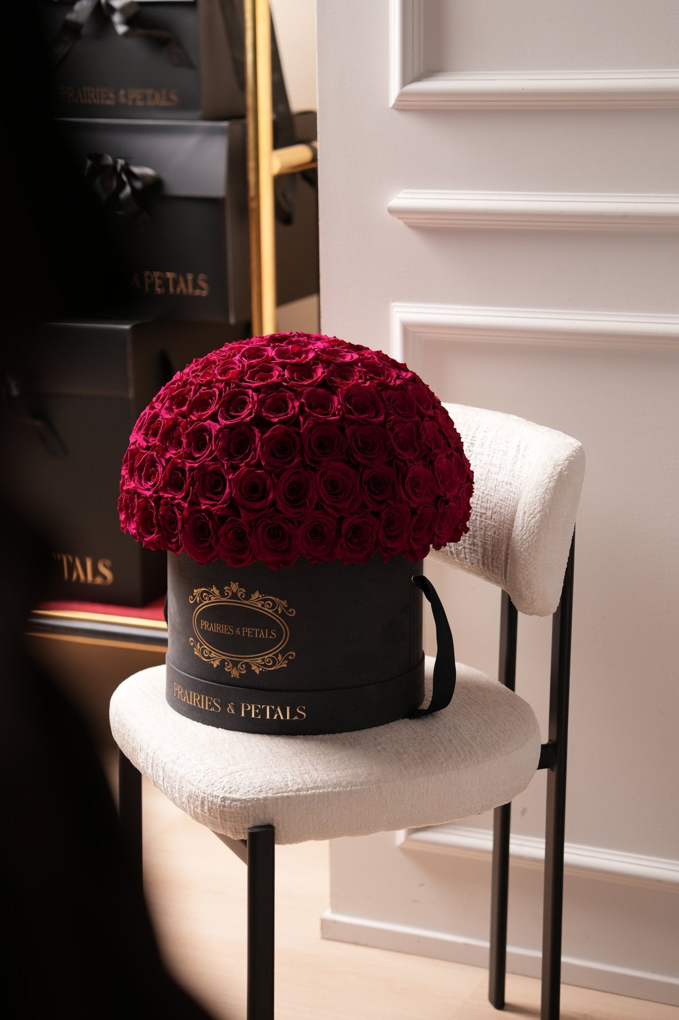 Burgundy roses, Fiorella by Prairies & Petals in a black suede hatbox
